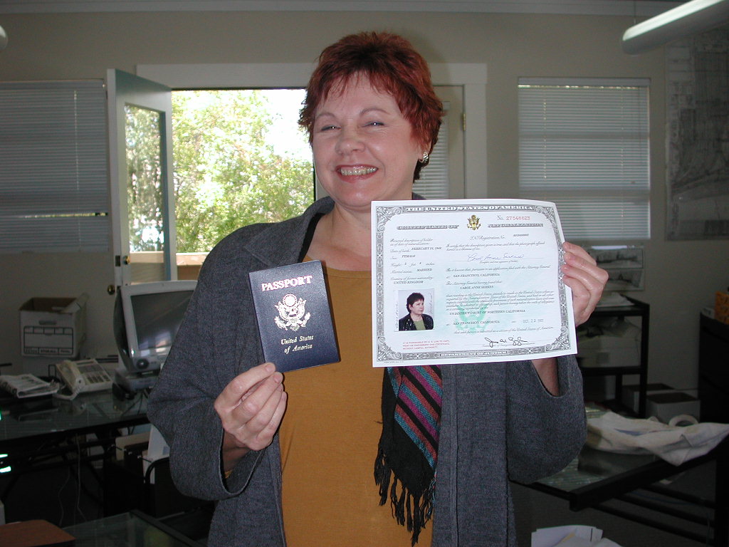 Carol holding her naturalization certificate