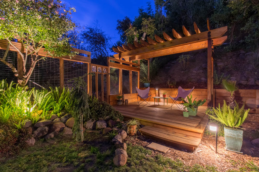 Twilight view of garden and deck - level yard in Berkeley Hills home